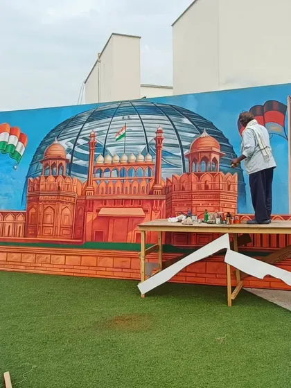 Me working on the final details of the Red Fort mural. This piece combines national landmarks with a bright, celebratory feel.
