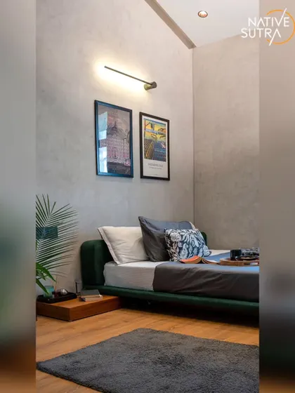 A wider view of the loft bedroom, showing the simple yet effective layout. The space is designed to be uncluttered and functional, reflecting a modern, urban lifestyle.