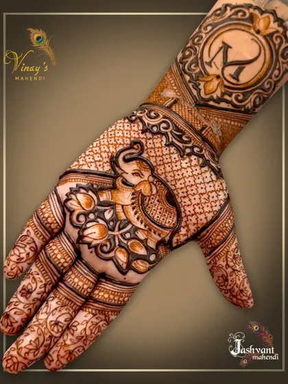 A close-up of a back-of-hand design with an elephant and lotus motif, personalized with the initial 'K'.