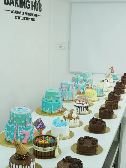 A stunning display of cakes from our 5-Day Cake Making and Decorating Masterclass. This photo captures the incredible variety and creativity our students unleash, from drip cakes to tiered designs.