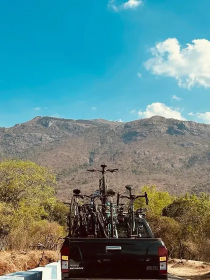Our support vehicle is always close by, carrying bikes and gear against the stunning backdrop of the Nilgiri mountains. We handle all the logistics so you can focus on the ride.