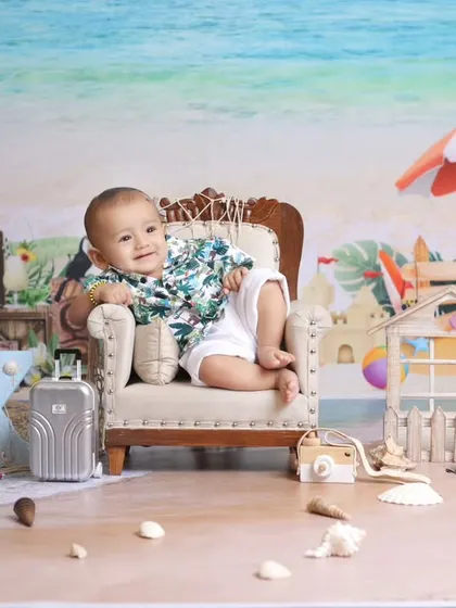 A relaxing day at the beach, right in our studio. This beach-themed setup includes a miniature chair, surfboard props, and a sandy floor to create a perfect summer vacation vibe.