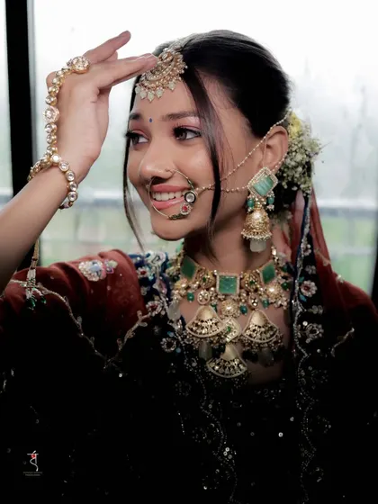 A close up that captures the bride's beautiful smile and the details of her emerald jewellery. The soft glam makeup enhances her features without looking heavy.