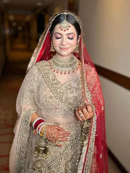 A lovely shot of the bride in her beige and red bridal outfit, complemented by our matching jewellery.