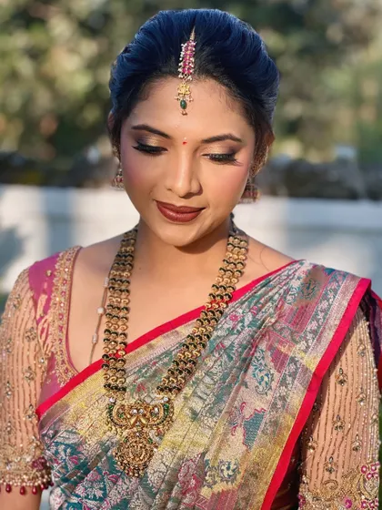 A close-up of the beautiful makeup for Sneha's farmhouse warming. The warm, earthy tones on her eyes and lips perfectly suit the outdoor setting.