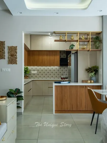 An open-plan view showing the living room, dining area, and a peek into the kitchen. The design uses partitions and distinct decor elements, like the fluted wood panel in the dining area, to define each space while maintaining a cohesive flow.