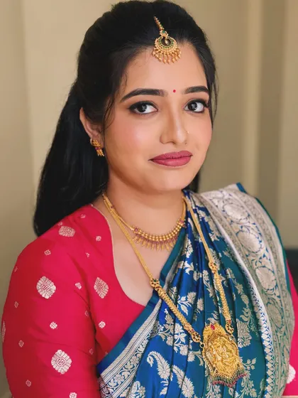 A close-up portrait of Navya's Varpooja makeup, featuring defined eyes and a soft lip.