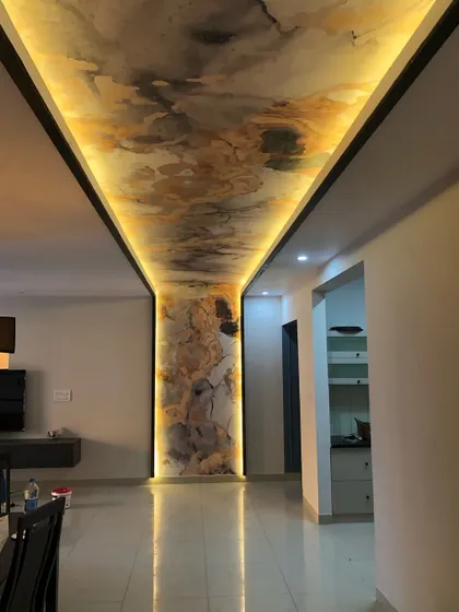 Wallpaper isn't just for walls. This project showcases a stunning abstract marble-effect wallpaper installed on a ceiling and pillar, with integrated backlighting to create a dramatic and luxurious entryway.