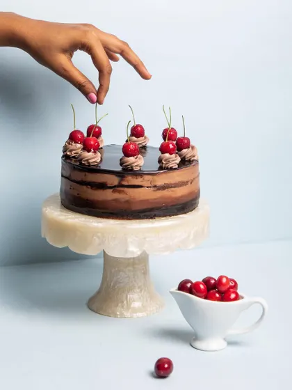 A close-up of my signature Chocolate Mousse Cake, showing the layers of light mousse and rich sponge. It's 100% eggless and a true crowd-pleaser.