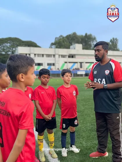 A close-up of a coach giving specific instructions to our young players before a match.