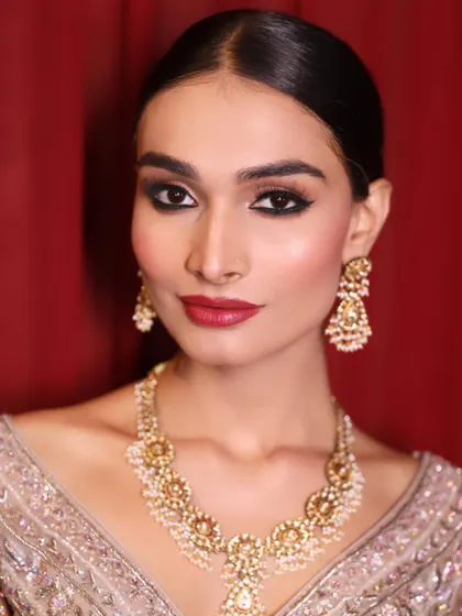 A classic smokey eye and red lip created by our students for a runway model. They learn to work quickly and efficiently in a fast-paced backstage environment.