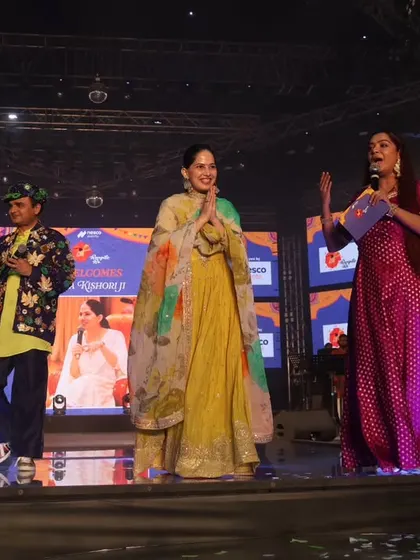 The full team on stage with Jaya Kishori. I am adept at managing multiple personalities on stage, ensuring everyone gets their moment to shine.