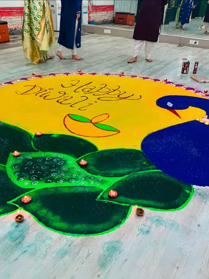 A close-up of the beautiful peacock rangoli our team created for the Diwali celebration.