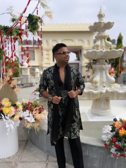 Posed and ready for action. The floral decor and grand fountain provide the perfect backdrop for the epic Baaraat I'm about to host.