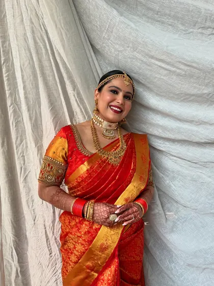 A happy and glowing bride. The matte skin finish and vibrant red lip create a look of timeless beauty and elegance.