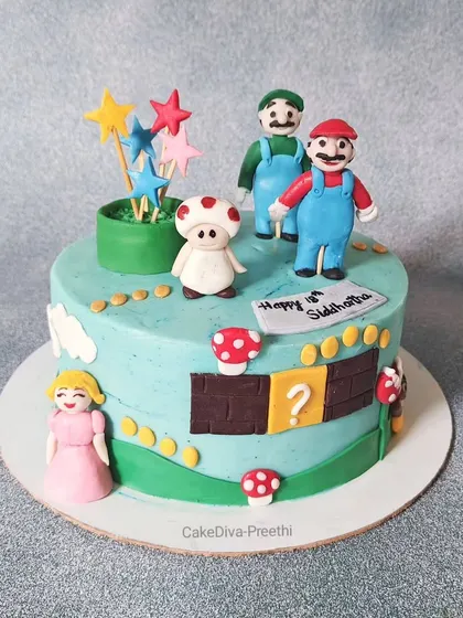 It's-a-me, Mario! This Super Mario-themed cake features hand-sculpted figures of Mario, Luigi, Princess Peach, and Toad, set in a classic game level scene.