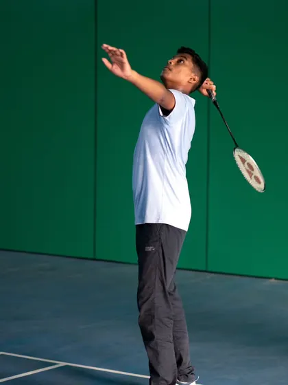 Another look at our player practicing his serve, a critical part of the game that we emphasize in our adult coaching programs.