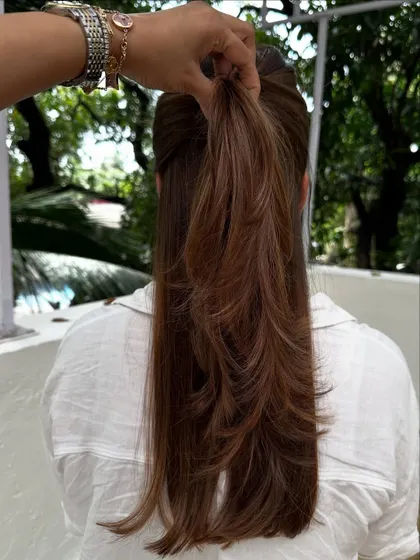 Holding up a section to show the beautiful, feathered layers and the seamless color.