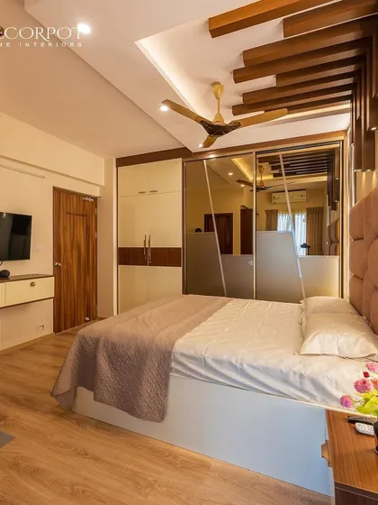 This bedroom is a masterclass in atmospheric design, with dramatic ceiling details, integrated lighting, and a stunning mirrored wardrobe. The space feels both grand and intimately cozy.