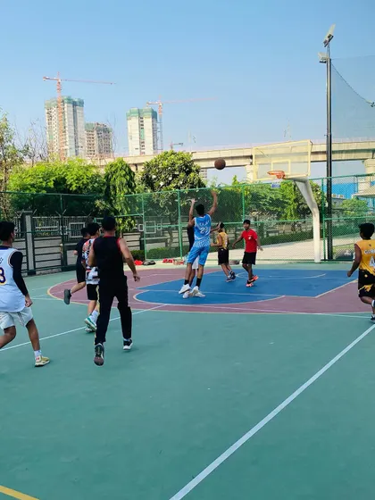 A player takes a jump shot during a fast break.