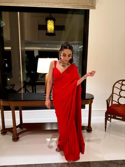 A full-length shot of my self-designed red saree. This look is all about making a statement with a bold color and a simple, elegant drape.