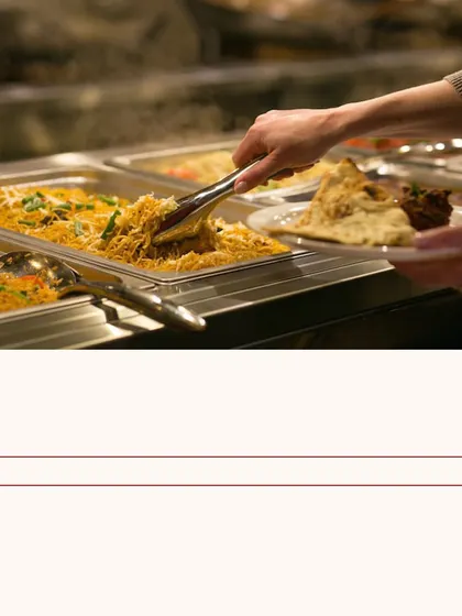No stress, just impress with our catering. A guest helps themselves to our buffet, a testament to the enjoyable experience we provide.