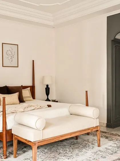 In this master bedroom from the Ivy Lane Villa, I used classic dark wood wardrobes that recede into an arched alcove, creating a sense of depth. The four-poster bed and muted tones contribute to a calm, colonial-inspired elegance.