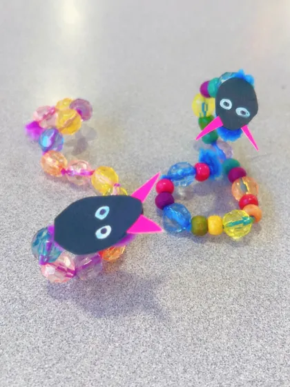 This little beaded snake is ready to wiggle its way home.