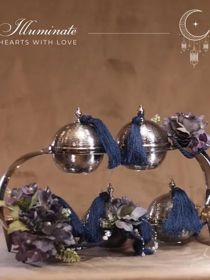 "Illuminate hearts with love." Our crescent-shaped server with lidded bowls, adorned with deep blue tassels, is a sophisticated and heartfelt gift for Eid.