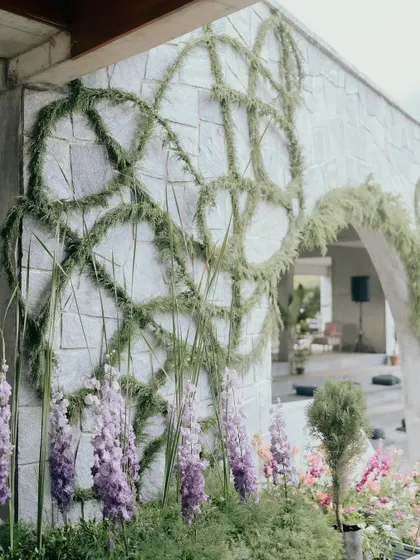 Another angle of the custom greenery installation. Every curve and line was intentionally placed by our team to create a sense of movement and natural elegance on the building's facade.