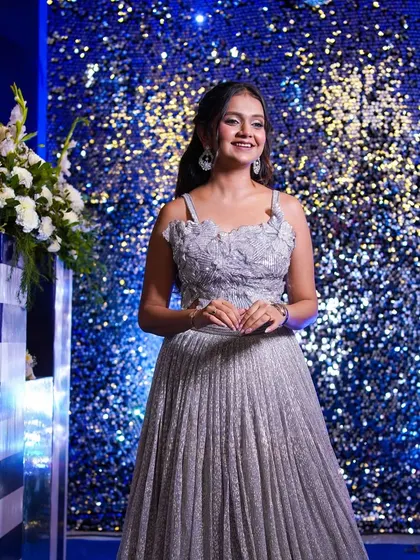 The full look against a sparkling blue backdrop, perfect for a Sangeet or cocktail party.