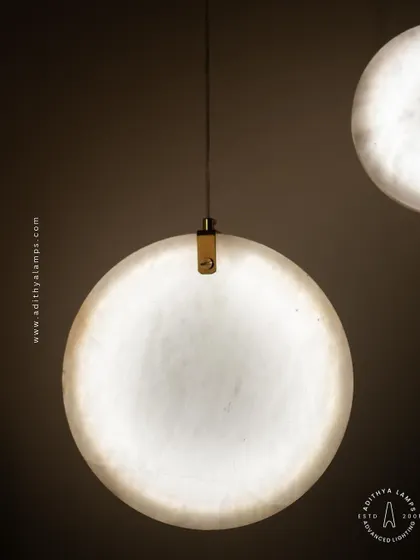 Showcasing our disc-shaped marble pendants. The light emanates softly through the thin slice of natural marble, revealing its unique veining. These fixtures are available in different shapes and look stunning hung in pairs or trios.