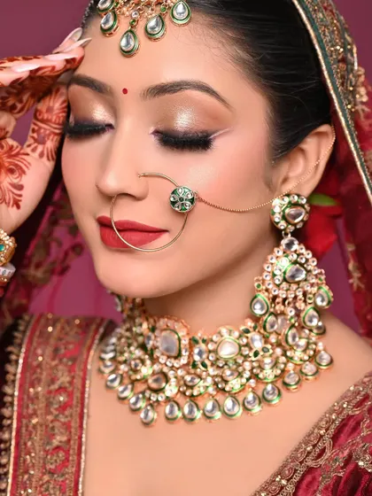 A classic red lip bridal makeup done by one of my students. The winged liner and gold shimmer on the eyes create a timeless and festive look.