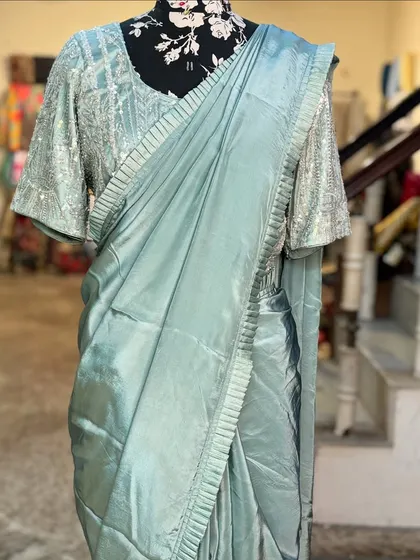 The 'MANOHARI' saree without its jacket, showcasing the beautifully crafted blouse with flared sleeves and the simple, elegant drape of the saree.