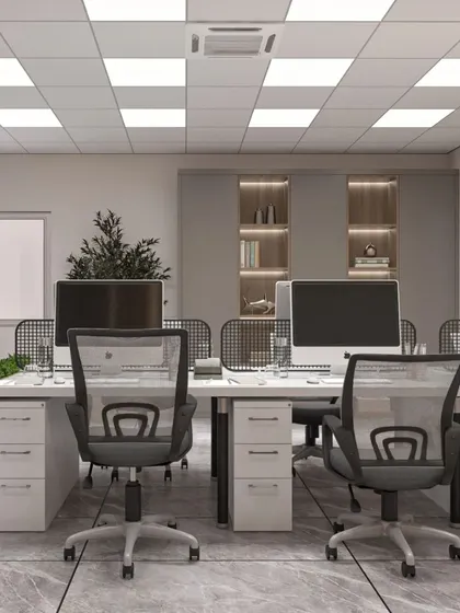 A modern open office layout with clean white desks and ergonomic chairs. This design maximizes space and encourages collaboration among team members.