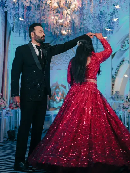The first dance as husband and wife. We captured this beautiful moment of the groom twirling his bride in her stunning red reception gown.