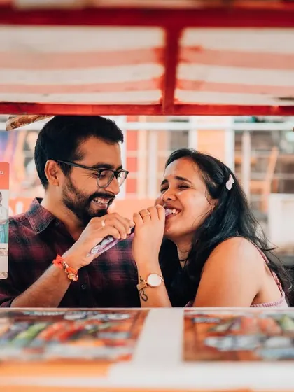 Sharing a laugh at a street food stall, this candid pre-wedding photo captures the simple joys of being together. We believe the best moments are often the most ordinary ones.