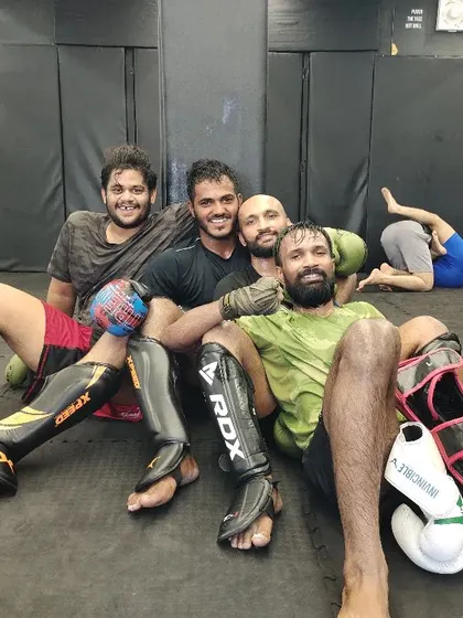 We are brothers from the wolfpack. After a tough sparring session, it's all smiles and camaraderie. We will reach the top together.