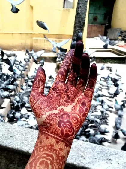 The movement in this photo highlights the way the henna adorns the hand.