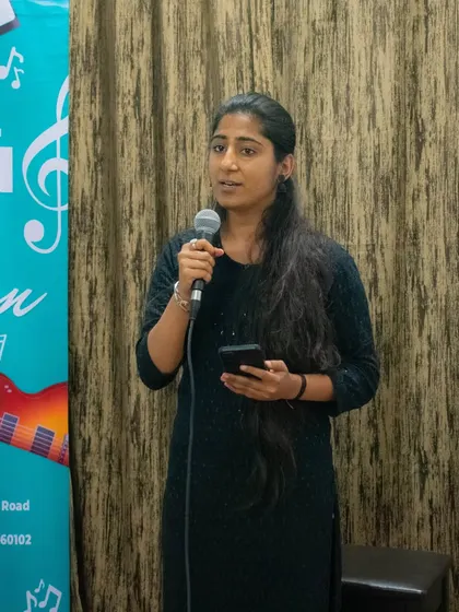 A student sharing her performance at the HSR branch open mic. These events are a great way for students to connect with each other.