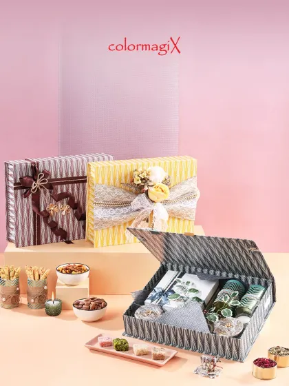 A collection of our premium festive box hampers, featuring textured paper and elegant ribbon work. These boxes can be customized with different color schemes and fillings to suit your needs.