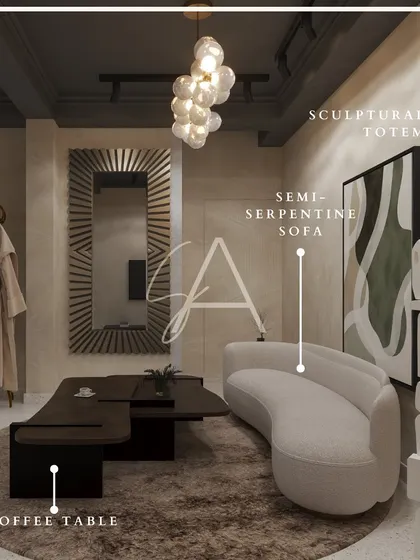 This vignette showcases a semi-serpentine sofa and a sculptural coffee table. The curved forms and moody lighting create an artistic and sophisticated display within the furniture studio.