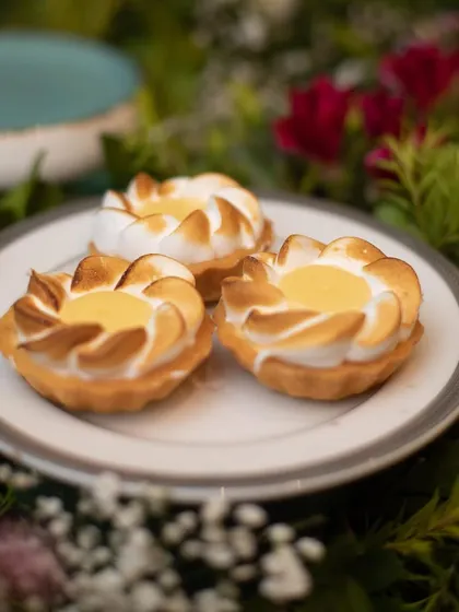 Delicate lemon meringue tarts, perfectly browned and ready to be served. Our pastry chefs excel at creating classic desserts with precision and flair.