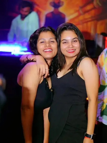 Friends enjoying the music and each other's company. A successful night is one filled with smiles and good times.