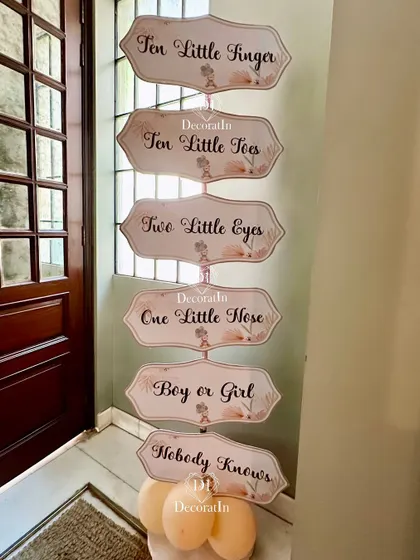 A whimsical directional sign for a baby shower with a sweet poem: "Ten little fingers, ten little toes..."