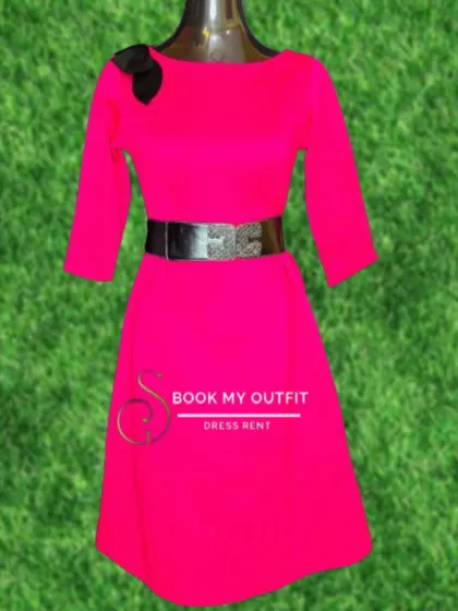 This bright pink dress, shown on a mannequin, features three-quarter sleeves and a wide, sparkling belt. It's a cheerful and stylish option for a party or special event.