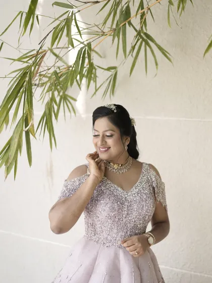 An outdoor shot that captures the ethereal quality of her reception look. The natural light enhances her glowing skin and the sparkle of her gown.