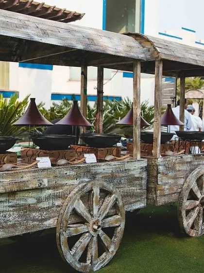 A unique rustic wooden cart designed to serve as a live station or a buffet counter for themed events.
