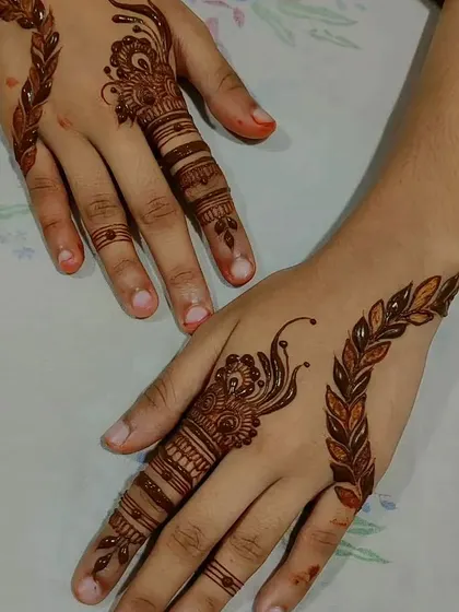 A simple yet striking design focusing on a single finger and a delicate vine.
