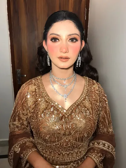 The complete look, showing the rich brown and gold outfit.